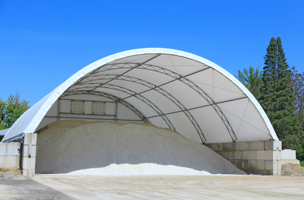 A doom shelter building made with a canvas material is used to store rock salt for icy conditions on the roadway