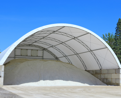 A doom shelter building made with a canvas material is used to store rock salt for icy conditions on the roadway